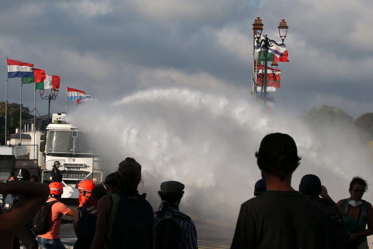 French anti-riot police use water canons to block protestors: EPA