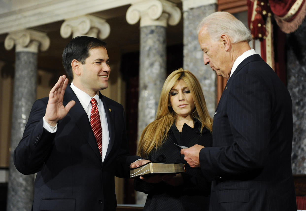 U.S. Senator Marco Rubio (R-FL) (L) stands next to his wife Jeanette Rubio as he takes part in a ceremonial re-enactment of his swearing-in by Vice President Joe Biden in the Old Senate Chamber at the U.S. Capitol in Washington January 5, 2011. REUTERS/Jonathan Ernst (UNITED STATES - Tags: POLITICS)