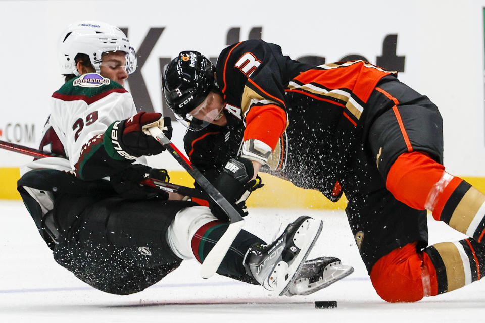 Arizona Coyotes forward Barrett Hayton, left, collides with Anaheim Ducks defenseman John Klingberg during the first period of an NHL preseason hockey game Wednesday, Sept. 28, 2022, in Anaheim, Calif. (AP Photo/Ringo H.W. Chiu)