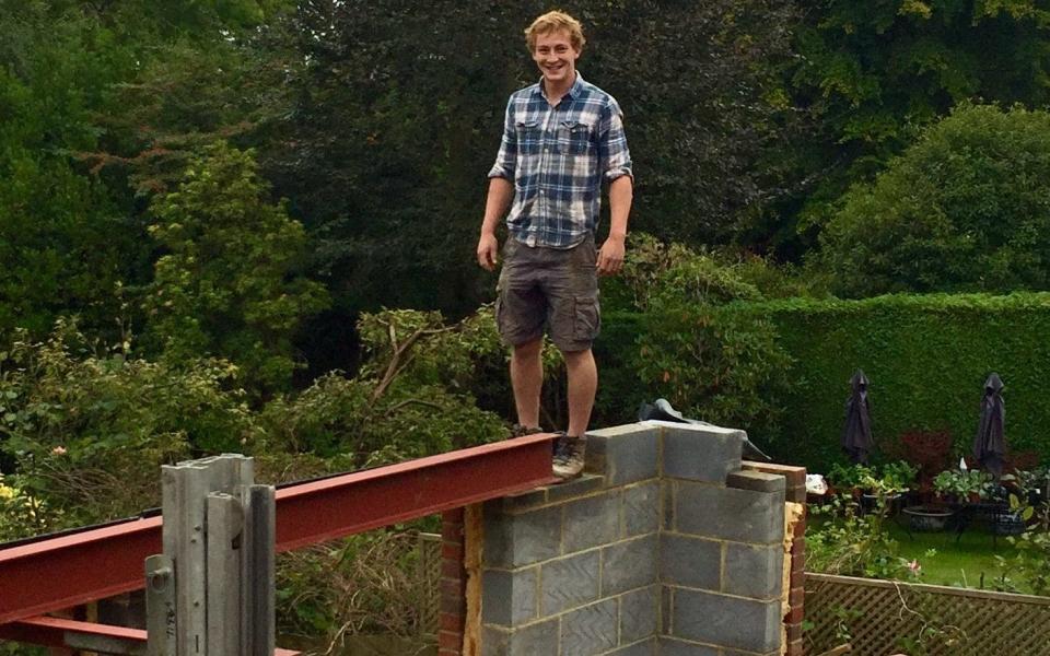 Lewis, one of the builders, on top of the extension