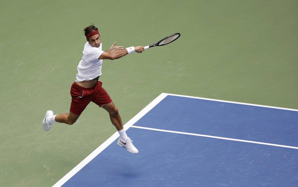 Roger Federer, of Switzerland, returns a shot to Benoit Paire, of France, during the second round of the U.S. Open tennis tournament, Thursday, Aug. 30, 2018, in New York. (AP Photo/Kevin Hagen)