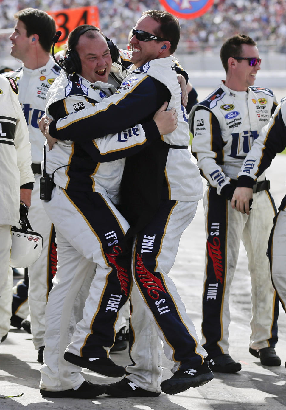 The pit crew for Brad Keselowski celebrates after winning the Kobalt 400 NASCAR Sprint Cup Series auto race on Sunday, March 9, 2014, in Las Vegas. (AP Photo/Julie Jacobson)