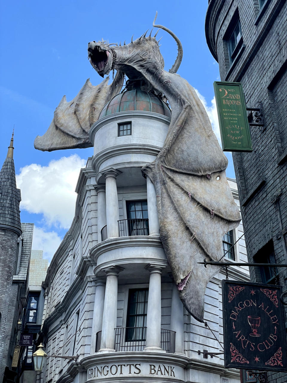 A photo of a large dragon on top of a crooked building