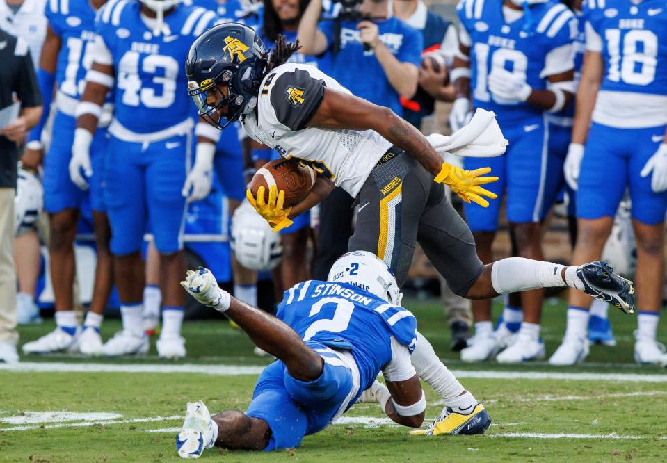 North Carolina A&T's Taymon Cooke (18) avoids a tackle attempt from Duke's Jaylen Stinson (2) during the first half of an NCAA college football game in Durham, N.C., Saturday, Sept. 17, 2022. (AP Photo/Ben McKeown)