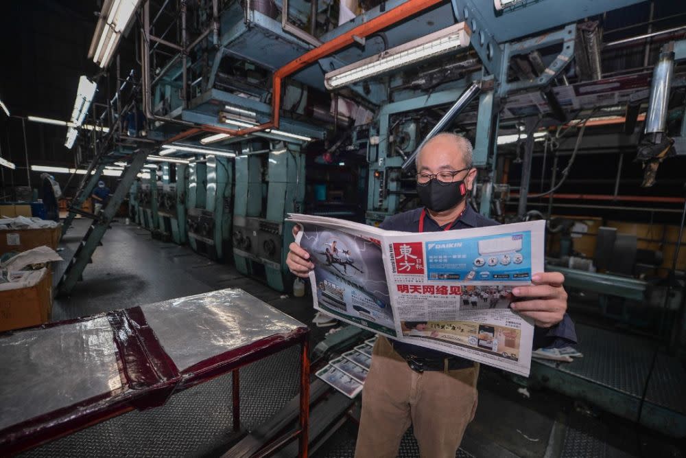 Editor-in-chief of Oriental Daily Ding Lee Leong reads a copy of the final edition of the newspaper April 16, 2021. — Picture courtesy of Oriental Daily