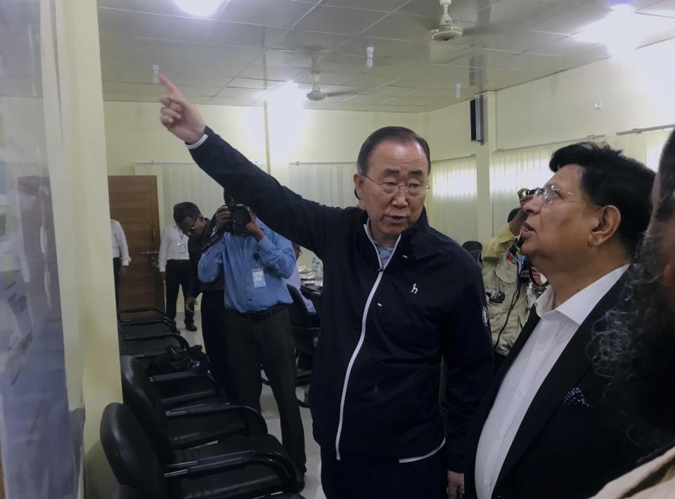 In this Wednesday, July 10, 2019 photo, former U.N. Secretary-General Ban Ki-moon, center, gestures as he is briefed by Bangladesh foreign minister A.K.Abdul Momen, right during a vist to the Kutupalong Rohingya refugees camp in the southern coastal district of Cox's Bazar, Bangladesh. Ban has expressed concern that monsoon floods could threaten the lives of Rohingya refugees in sprawling camps in Bangladesh. (AP Photo/ Al-emrun Garjon)