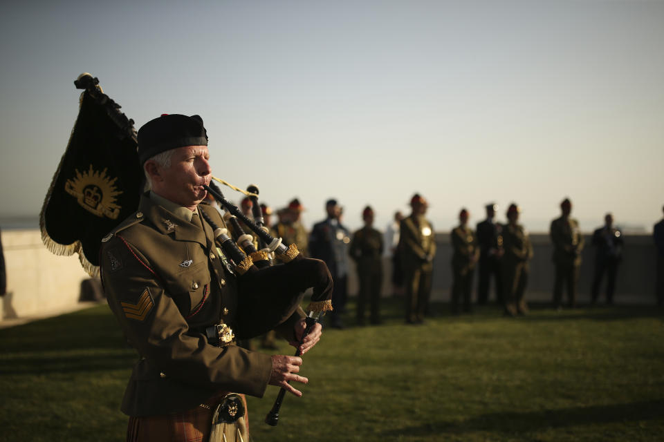 British, Australian and New Zealand soldiers attend a ceremony at the Helles Memorial in the Gallipoli peninsula, Turkey, Sunday, April 24, 2022. The annual Anzac Day ceremony on Monday, April 25 remembers the forces of the Australian and New Zealand Army Corps under British command in World War I who fought a bloody nine-month battle against Turkish forces on the Gallipoli peninsula in 1915. (AP Photo/Emrah Gurel)