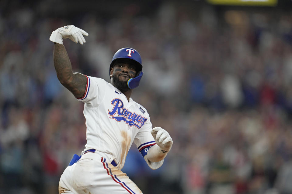 Texas Rangers' Adolis Garcia celebrates after hitting a game-winning home run against the Arizona Diamondbacks during the 11th inning in Game 1 of the baseball World Series Friday, Oct. 27, 2023, in Arlington, Texas. The Ranger won 6-5. (AP Photo/Godofredo A. Vásquez)