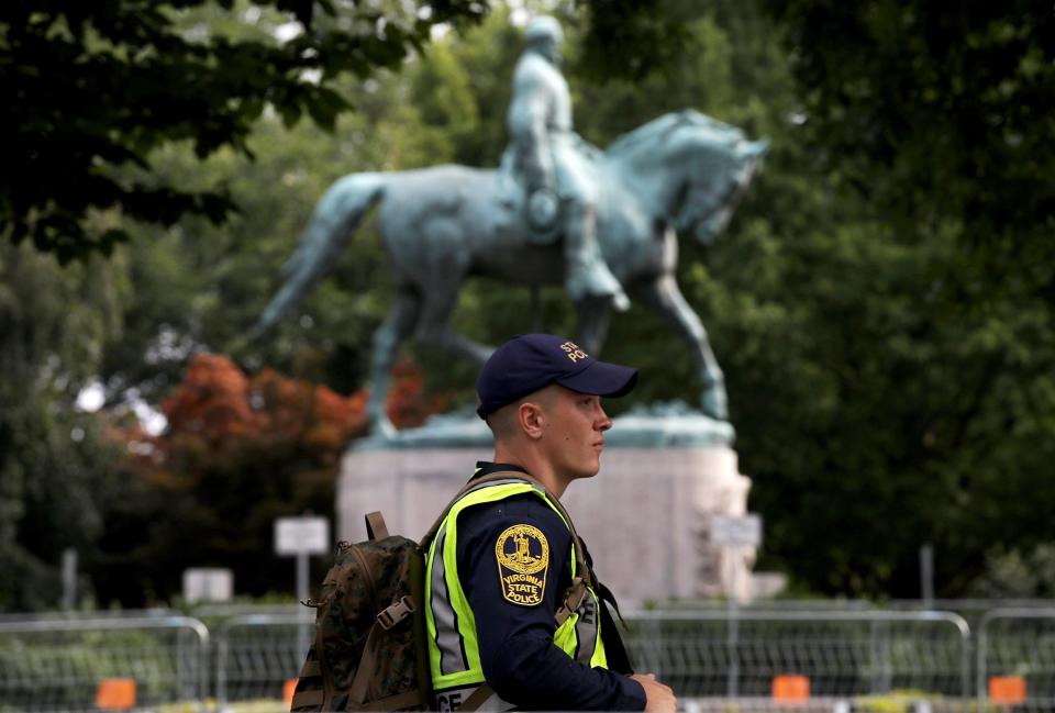 A member of the Virginia State Police waits outside the park where a statue of Confederate Gen. Robert E. Lee  is located August 11, 2018 in Charlottesville, Virginia.