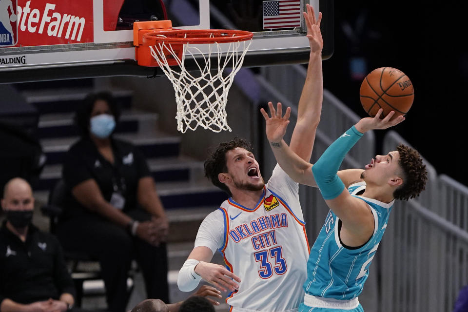 Charlotte Hornets guard LaMelo Ball shoots over Oklahoma City Thunder forward Mike Muscala during the first half of an NBA basketball game in Charlotte, N.C., Saturday, Dec. 26, 2020. (AP Photo/Chris Carlson)