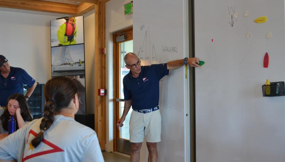 Col. Patrick Powers explains the concept of slowing down and stopping a sailboat to Gold Star Sailing campers in a classroom at Sail Newport's facility inside Fort Adams State Park on Monday, July 31 2023.