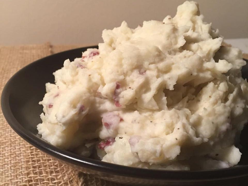 Smashed parmesan potatoes piled in a bowl