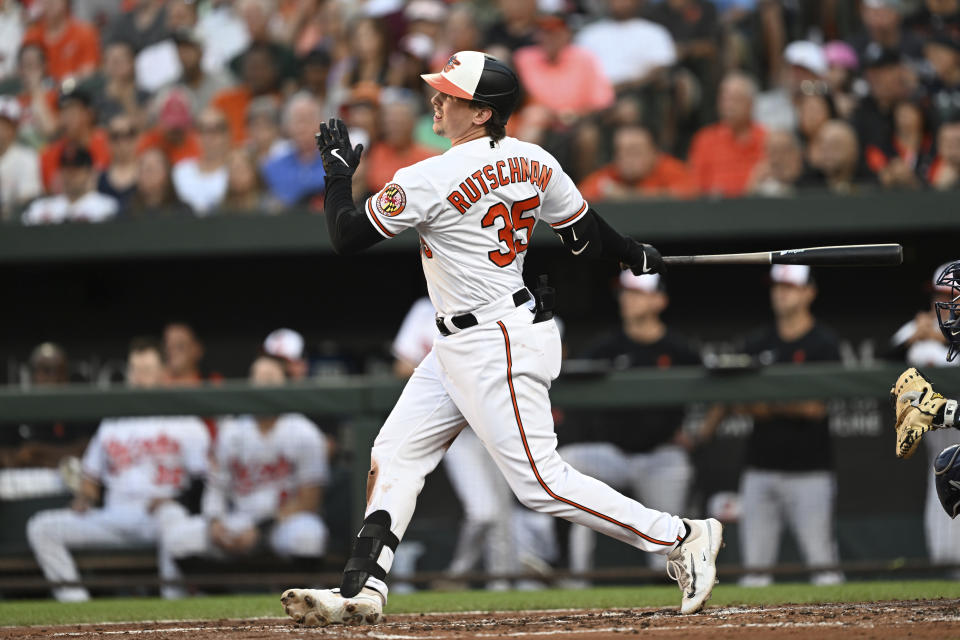 Baltimore Orioles' Adley Rutschman follows through on an RBI single against the New York Yankees in the first inning of a baseball game Sunday, July 30, 2023, in Baltimore. (AP Photo/Gail Burton)