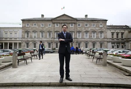 Ireland's Minister of State for Finance Simon Harris poses for a picture in front of Leinster House in Dublin March 5, 2015. REUTERS/Cathal McNaughton