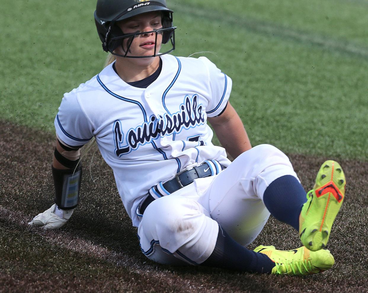 Matti Benson of Louisville slides safely into third base on a double steal during a Division I district semifinal at Austintown Fitch, Monday, May 16, 2022.