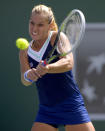 Dominika Cibulkova, of Slovakia, returns a shot to Li Na, of China, during a quarterfinal match at the BNP Paribas Open tennis tournament, Thursday, March 13, 2014 in Indian Wells, Calif. (AP Photo/Mark J. Terrill)