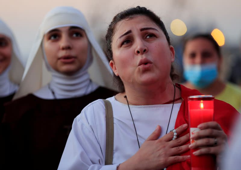 People attend a prayer near the site of a massive explosion in Beirut