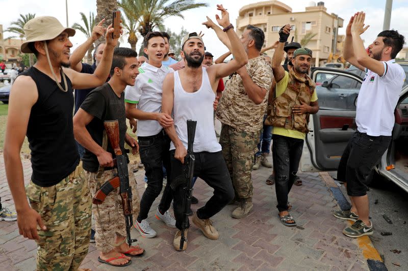 Fighters loyal to Libya's internationally recognised government celebrate after regaining control over Tarhouna city