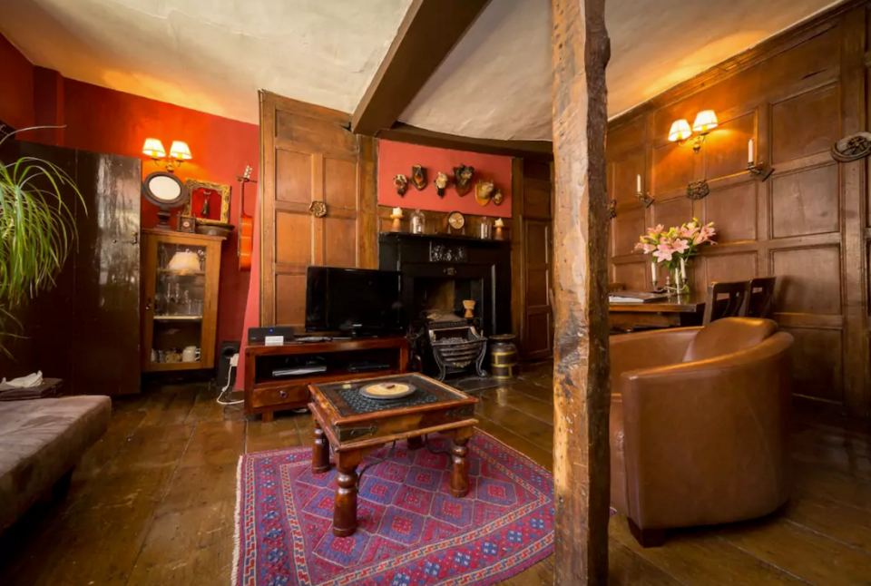 <p>The owner claims the haunted chamber is more than 600 years old. Can’t you picture the fireplace in the corner of the living room eerily springing to life? (Airbnb) </p>