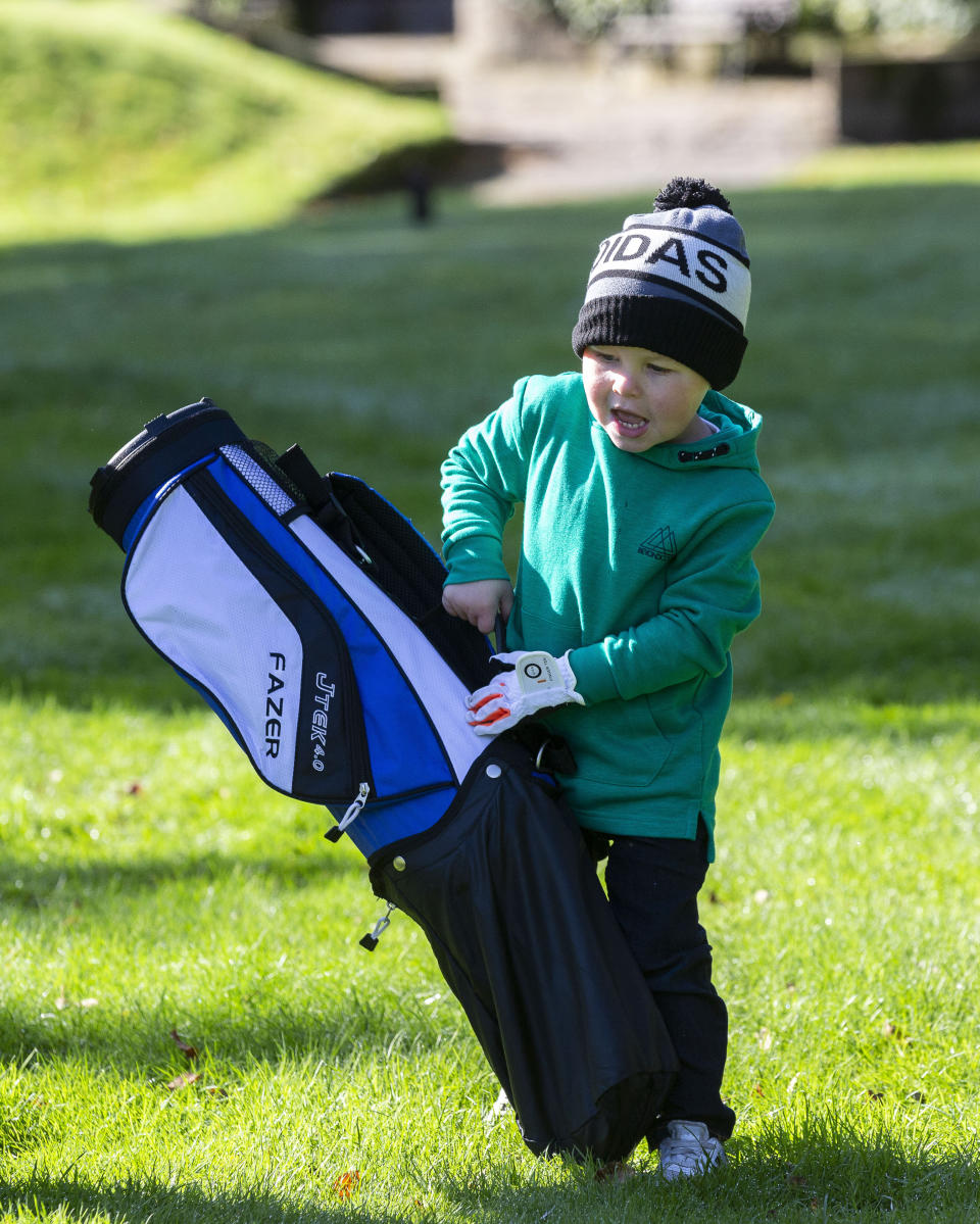 George has been banned from playing with real golf balls in his back garden. (Credit: SWNS) 