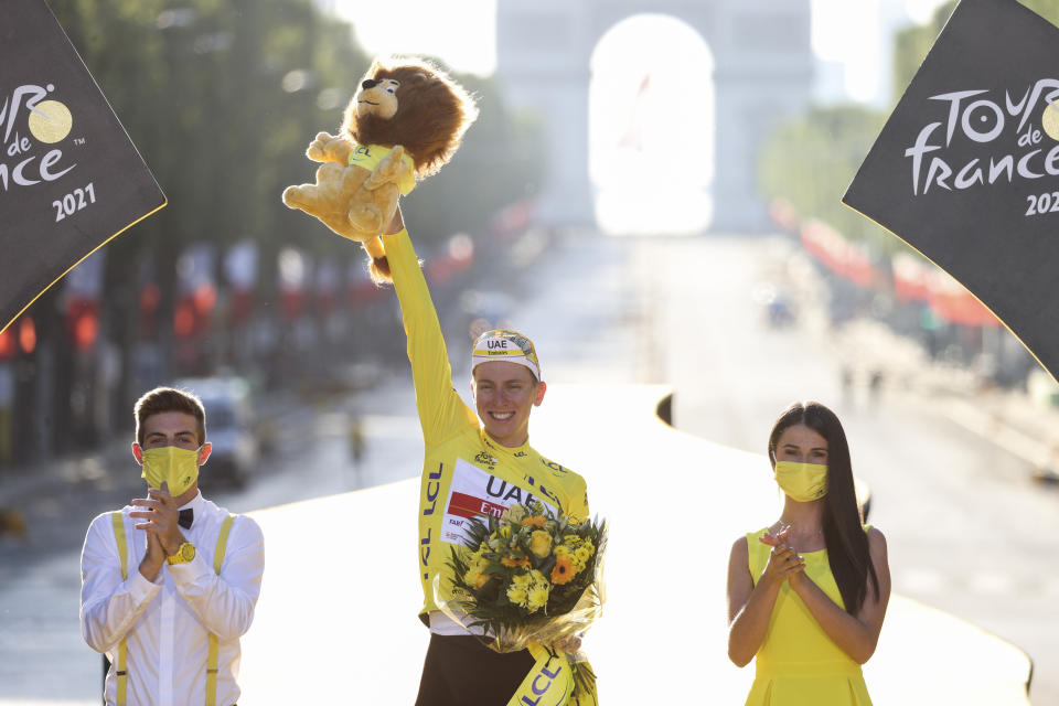 Tour de France winner Slovenia's Tadej Pogacar, wearing the overall leader's yellow jersey, celebrates on the podium after the twenty-first and last stage of the Tour de France cycling race over 108.4 kilometers (67.4 miles) with start in Chatou and finish on the Champs Elysees in Paris, France,Sunday, July 18, 2021. (Garnier Etienne/L'Equipe via AP, Pool)