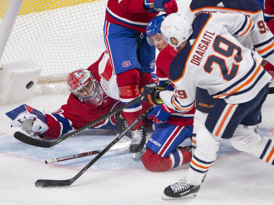 Edmonton Oilers' Leon Draisaitl (29) scores the third goal against Montreal Canadiens goaltender Cayden Primeau (30) during the second period of an NHL hockey game, Wednesday, May 12, 2021 in Montreal. (Ryan Remiorz/Canadian Press via AP)