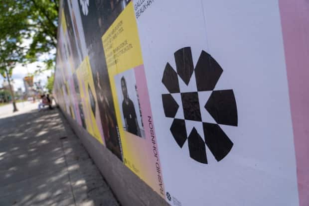 The National Gallery of Canada's new logo is seen on posters outside the Ottawa gallery's location on June 23, 2021. According to the gallery, the circular motif relates to 'Indigenous ways of knowing and being.' (Francis Ferland/CBC - image credit)