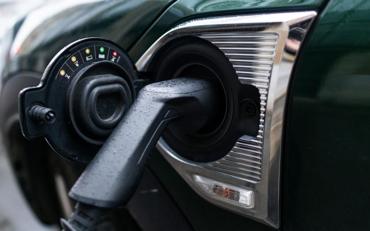 An electric charging plug connected to a Mini Countryman Plug-in All4 Hybrid automobile, manufactured by Bayerische Motoren Werke AG (BMW), in Paris, France - Benjamin Girette /Bloomberg 