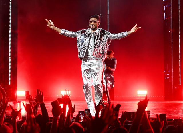 Usher distracts fans with huge bulge as he strips off for