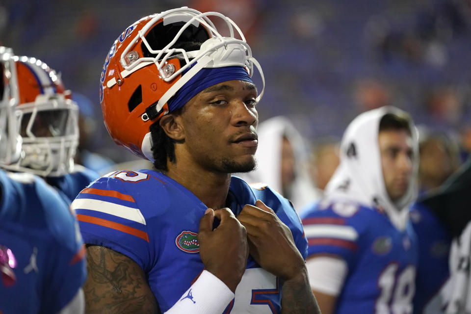 Florida quarterback Anthony Richardson gathers with teammates as the band plays the school song after Florida they were defeated by LSU in an NCAA college football game, Saturday, Oct. 15, 2022, in Gainesville, Fla. (AP Photo/John Raoux)