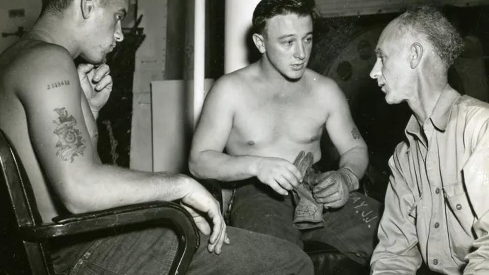 Ernie Pyle, war correspondent, interviews Joe J. Ray and Charles W. Page on board the USS Yorktown on Feb. 5, 1945. (Courtesy of the U.S. National Archives)