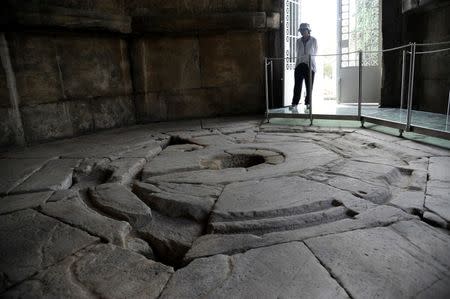 A guard is seen inside the Tower of the Winds, open to the public for the first time in more than 200 years after being restored, in the Roman Agora, in Plaka, central Athens, Greece, August 23, 2016. Picture taken August 23, 2016. REUTERS/Michalis Karagiannis