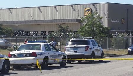 Police vehicles are seen outside a UPS service center following a deadly shooting in Birmingham, Alabama September 23, 2014. REUTERS/Sherrel Wheeler Stewart