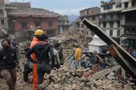 People clear rubble in Kathmandu's Durbar Square, a UNESCO World Heritage Site that was severely damaged by an earthquake on April 25, 2015