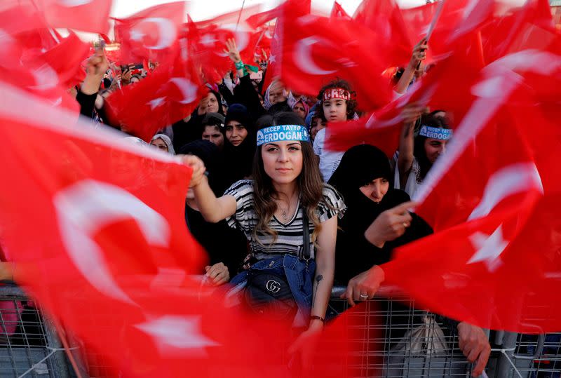 FILE PHOTO: Supporters of Turkish President Erdogan wave national flags during a ceremony marking the third anniversary of the attempted coup at Ataturk Airport in Istanbul,