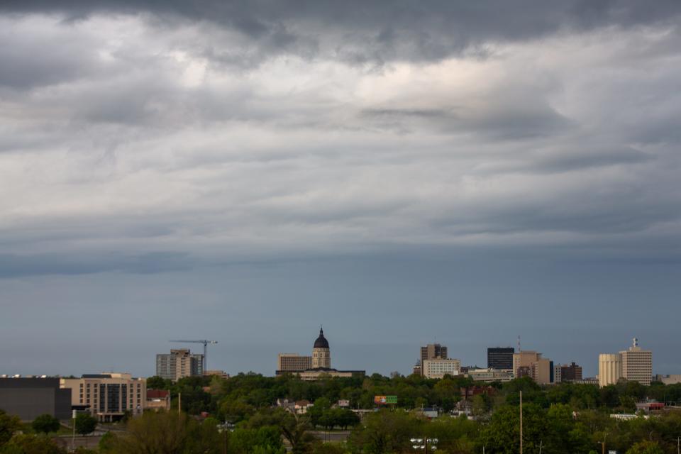 Overcast clouds fill the sky above Downtown Topeka as seen from Quinton Heights hill on May 4, 2023.