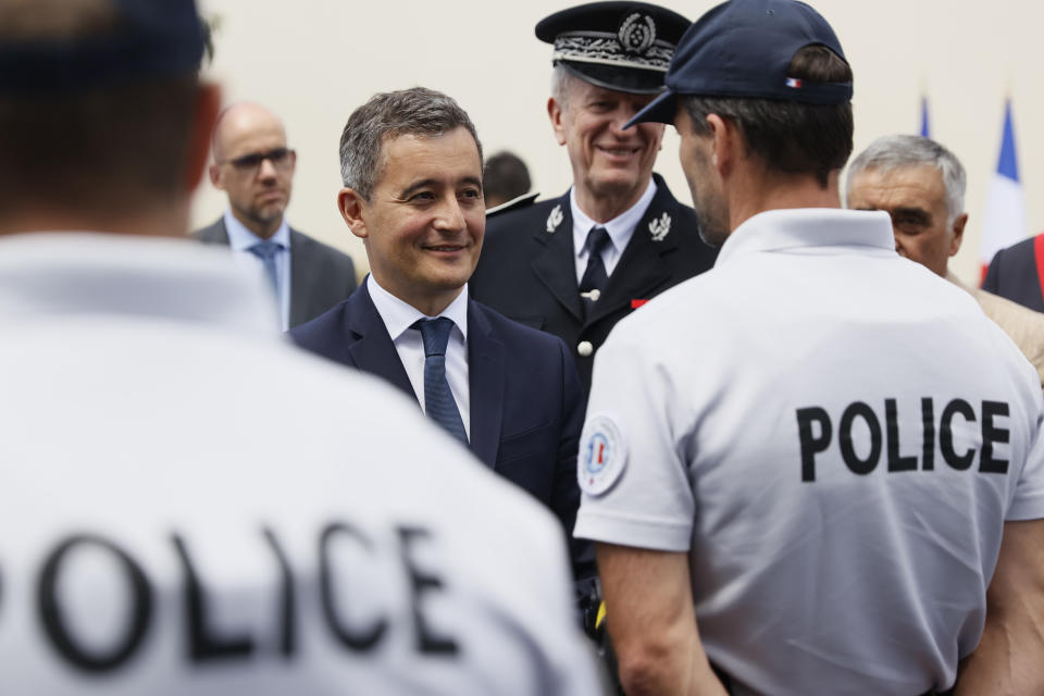 Newly appointed Interior Minister Gerald Darmanin, center, talks to police officers during a visit of a police headquarters in Les Mureaux, outside Paris, Tuesday, July 7, 2020. Former budget minister Darmanin was named to replace Interior Minister Christophe Castaner, who had come under fire amid widespread French protests against racial injustice and police brutality spurred by the death of George Floyd in the United States. (Thomas Samson, Pool via AP)