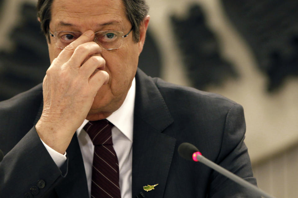 Cyprus's President Nicos Anastasiades adjusts his glasses before speaking during a national televised news conference at the Presidential Palace in Nicosia, Cyprus, Wednesday, Feb. 12, 2014. Anastasiades held the conference to defend a document he agreed with Turkish Cypriot leader Dervis Eroglu that paved the way for the resumption of negotiations a day earlier aimed at reunifying the war-divided island. Anastasiades faces strong pressure from critics who argue that the document contains the seeds of possible Turkish Cypriot statehood, which could unravel any peace accord. (AP Photo/Petros Karadjias)