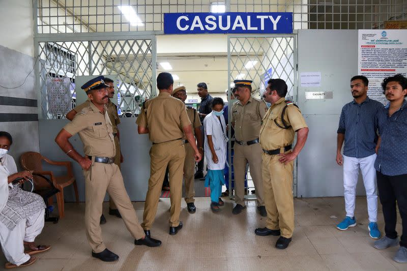 Policemen stand guard at the entrance of the casualty ward of a hospital where injured devotees were admitted after multiple blasts occurred during a religious gathering of Jehovah's Witnesses, in Kochi