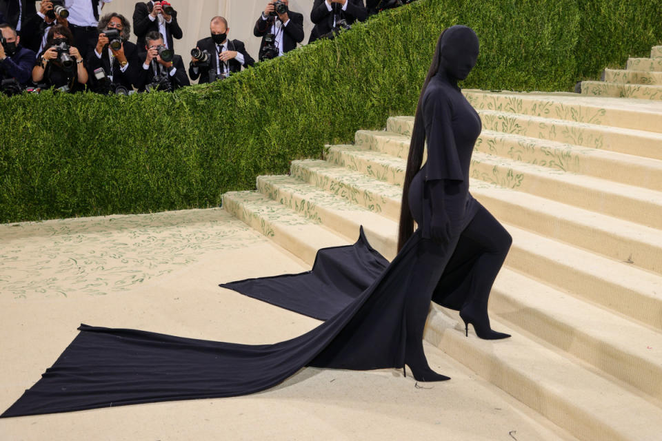 <p>Theo Wargo/Getty Images</p><p>Kim Kardashian took head-to-toe black literally at the 2021 Met Gala. The Balenciaga look featured a long-sleeve turtleneck bodysuit, a T-shirt dress with train, boots, gloves and a mask.</p><p>A source <a href="https://people.com/style/kim-kardashian-says-she-fought-against-her-met-gala-mask-why-would-i-cover-my-face/" rel="nofollow noopener" target="_blank" data-ylk="slk:told PEOPLE;elm:context_link;itc:0;sec:content-canvas" class="link ">told <em>PEOPLE</em></a> that Kardashian was set on making a statement, calling the look a "new subculture."</p><p>"No logo, no face, but everyone knows it's her," the insider said. "Kanye gave her the courage to push creativity and people's imagination through art. It's the ultimate confidence."</p>