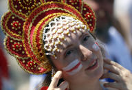 <p>A soccer fan with her face painted in the colours of the England national flag gestures outside the venue </p>