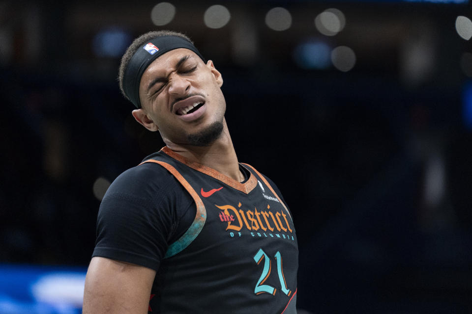 Washington Wizards forward John Butler Jr. reacts after being poked in the eye during the first half of an NBA basketball game against the Charlotte Hornets, Friday, Nov. 10, 2023, in Washington. (AP Photo/Stephanie Scarbrough)
