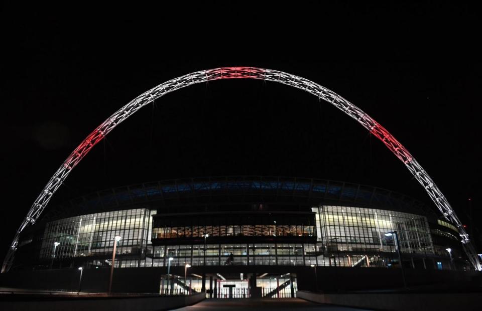 Wembley Stadium lit up after the Manchester concert bomb attack (PA)