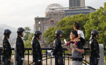 <p>With the Atomic Bomb Dome as a backdrop, passers-by move past riot police near Hiroshima Peace Memorial Museum in Hiroshima, southwestern Japan, Thursday, May 26, 2016. (Photo: Shuji Kajiyama/AP) </p>