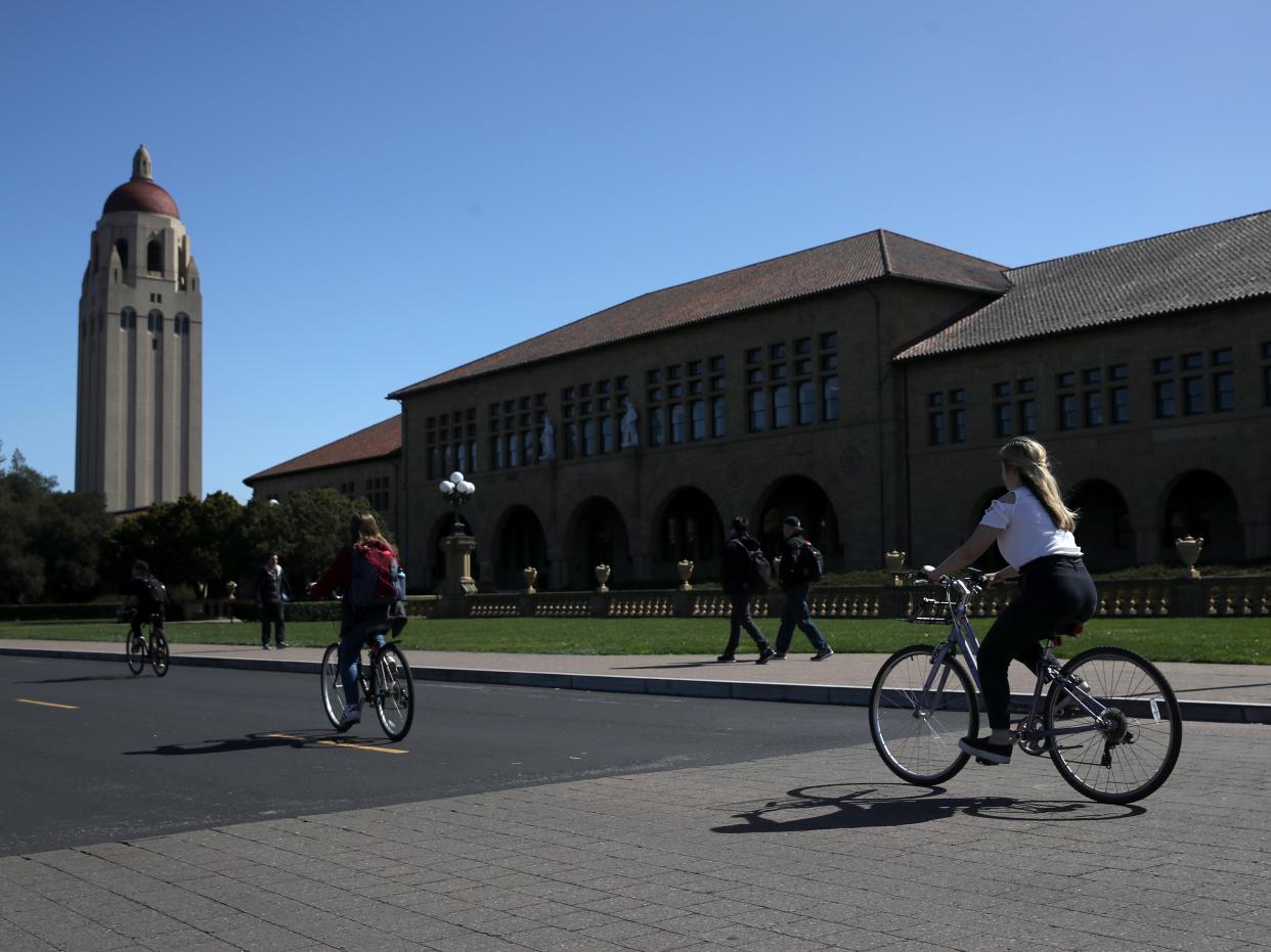 Cyclists ride by Hoover Tower on the Stanford University campus on 12 March 2019 in Stanford, California (Getty Images)