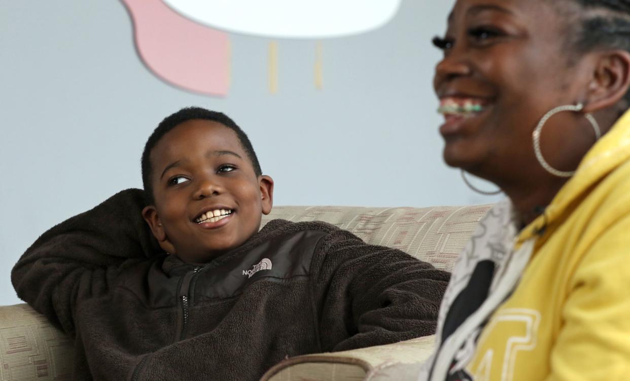 Nine-year-old J.D. Jackson smiles as he and his mother, Mary Jackson, talk to the media about J.D.’s new eye Thursday afternoon, Dec. 15, 2022, at the offices of the Gaston Gazette.