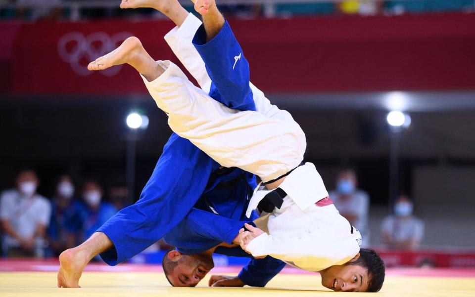 Japan's Naohisa Takato (white) competes with Georgia's Lukhumi Chkhvimiani during their judo men's -60kg quarterfinal bout - GETTY IMAGES