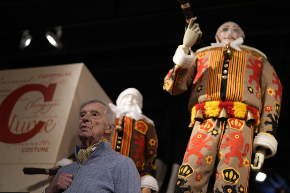 Christian Mostade, 88, speaks at the Museum of the Mask in Binche, Belgium, Wednesday, Feb. 1, 2023. After a COVID-imposed hiatus, artisans are putting finishing touches on elaborate costumes and floats for the renowned Carnival in the Belgian town of Binche, a tradition that brings together young and old and is a welcome moment of celebration after a rough few years. (AP Photo/Virginia Mayo)