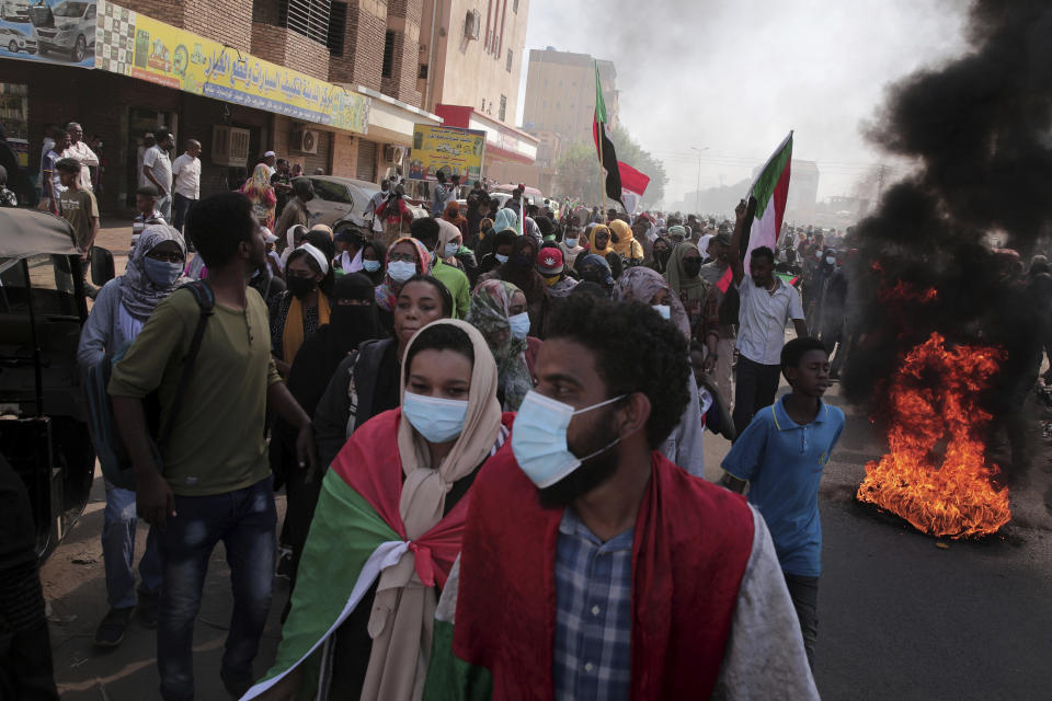 People chant slogans during a protest to denounce the October 2021 military coup, in Khartoum, Sudan, Thursday, Jan. 6, 2022. Sudanese took to the streets in the capital, Khartoum, and other cities on Thursday in anti-coup protests as the country plunged further into turmoil following the resignation of the prime minister earlier this week. (AP Photo/Marwan Ali)