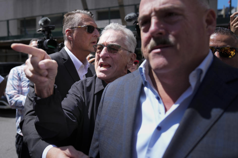 Robert De Niro, center, argues with a Donald Trump supporter after speaking to reporters in support of President Joe Biden across the street from Trump's criminal trial in New York, Tuesday, May 28, 2024. (AP Photo/Seth Wenig)